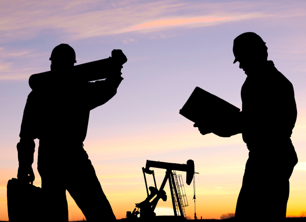 Silhouetted oil workers in front of a pump are probably wearing the latest nail fashion from skelzombie