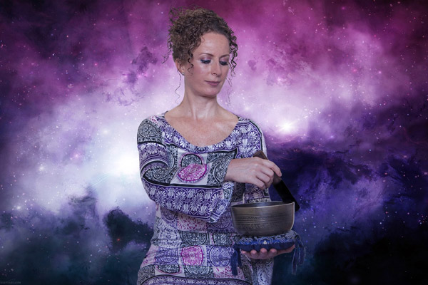 A spiritual looking woman mixes something in an ornate pot