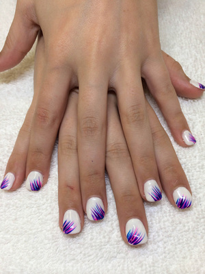 Pure white polished nails are set off by purple lash adornments from binh's