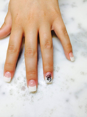 Manicure with French tips and elk-motif line art from Binh's in Edmonton