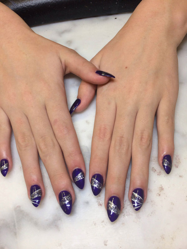 Lovely hands with deep purple polish host sparkling silver elements for a stunning finish from Binh's manicurists