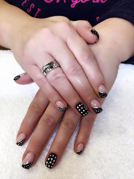 Attractive hands featuring squared nails with black and white design elements from Binh's Nails