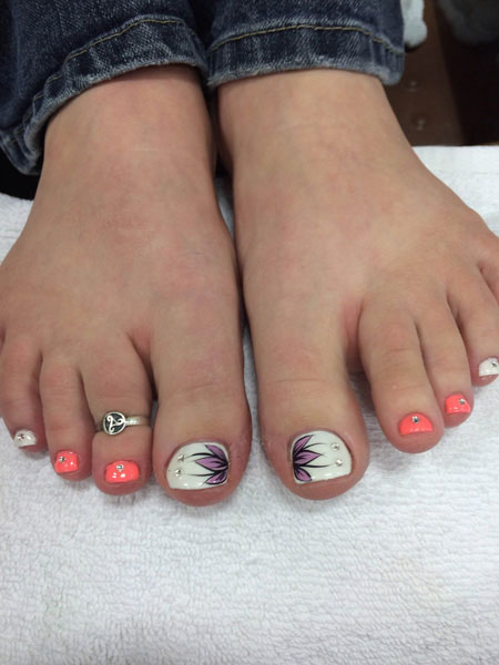 Feminine feet with various decorative touches on the toenails from the pedi artists at Binh's in Edmonton's east end