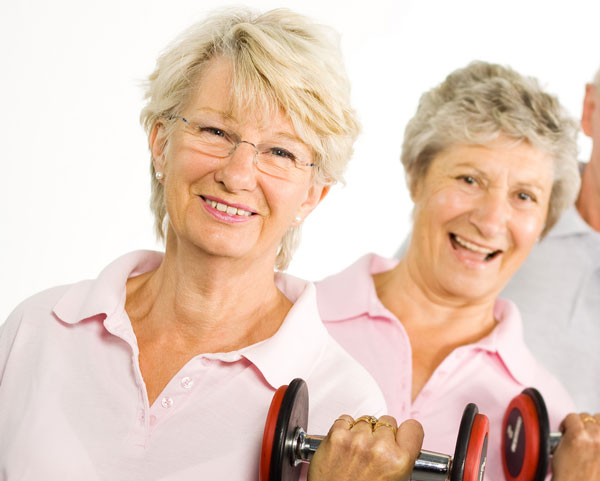 Senior ladies lifting weights points up how important nail care from Binh's Nails East can be