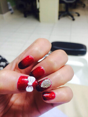 Blood red fingernails with glitter added, sets off the 3D gem and bow-tie flourishes in this exquisite Binh's Nails creation