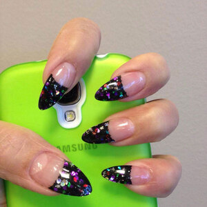 Claw shaped gel nails with black and glitter tips make a eye-catching presentation from Binh's Nails in Edmonton's east end