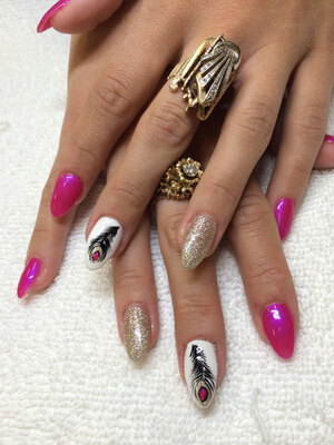 Womanly hands withalmond-sculpted nails in plain pink, white with feather motif and silver glitter from Binh's manicure salon in Edmonton