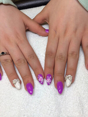 Beautiful hands with almond-shaped nails, unique colour and artistic elements for each nail and 3D touches; available at Edmonton manicure salon Binh's