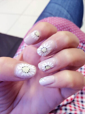 Pink fingernails with flowery adornments puts the merry in your mani at Binh's Nails in Edmonton