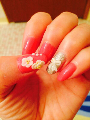 White petals on a pink polish background provide a lovely look from Binh's Nails