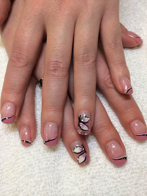 Female fingernails with clear polish and butterfly effects create a fun fashion statement from Binh's manicure salon in Edmonton