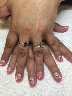 Small ivory flowers add a fun element to these artfully enhances nails from Binh's Nails on 17th St. in Edmonton's east end