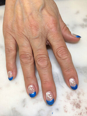 Oval nails with cameo-blue tips and matching white highlights are a beautiful creation of Binh's Nails on 17 Street.
