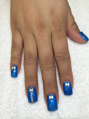 Shiny blue polish on square gels are accented with 3D design features at Binh's 