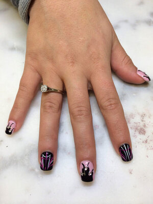 A youthful hand with opal and onyx highlights on a squared gel nail set provides stunning style from Binh's Nails