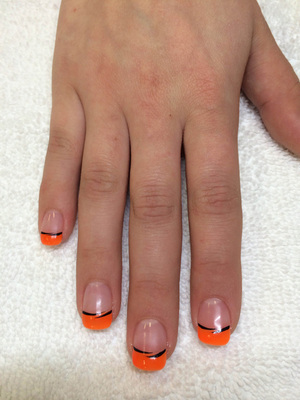 female fingernails polished clear with orange and black highlight elements from Binh's