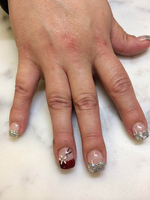 Polished fingernails with red and silver glitterhighlights are a great look from Binh's Nails