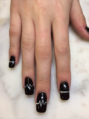 Heart monitor line art against a black background is a stunning look from Binh's Nails
