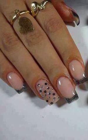 A lady's perfectly manicured fingernails featurimg glitter tips on a square gel platform from Binh's on 17 Street 