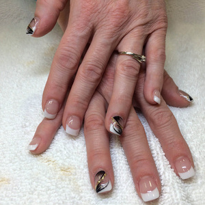 Binh's nails created this attractive manicure featuring French tips and black design elements for a lovely finsih