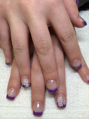 Matching, polished nails with purple and glitter tips and a white accent on the third fingers at Binh's.