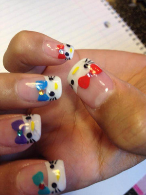 Fingernails bearing a kitten motif with different coloured bows create a spectacular style from Binh's manicures