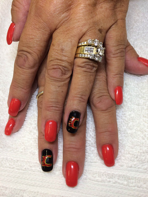 The "Flaming C" is a stylish centerpiece of this hockey-themed manicure design from Binh's