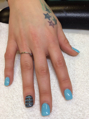 Robin's egg blue nail polish adorns these fingernails with the ring finger featuring a colour matched stripes