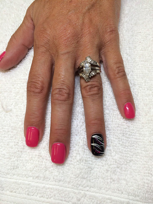Pink polished fingernails with a featured finger in black and silver from Binh's
