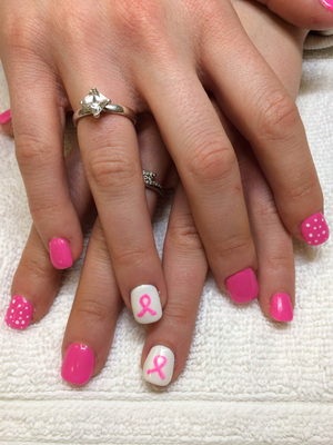 Pink nail polish is featured on these fingernails with a cancer ribbon motif created by Binh's