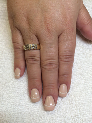 Fingers polished with off-white and a white line flourish is an attractive design at Binh's
