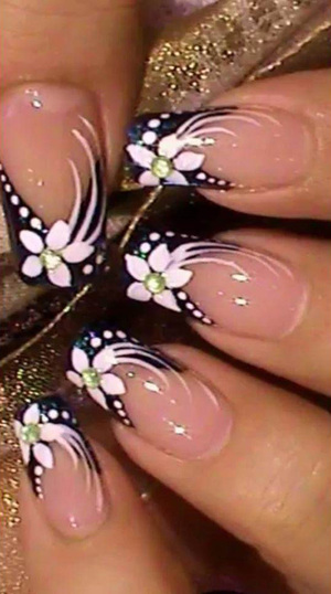 Light pink polished fingernails are expertly finished with black and white floral accents from Binh's