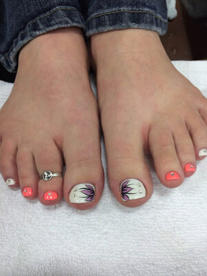 Feminine feet with various decorative touches on the toenails from the pedi artists at Binh's in Edmonton's east end